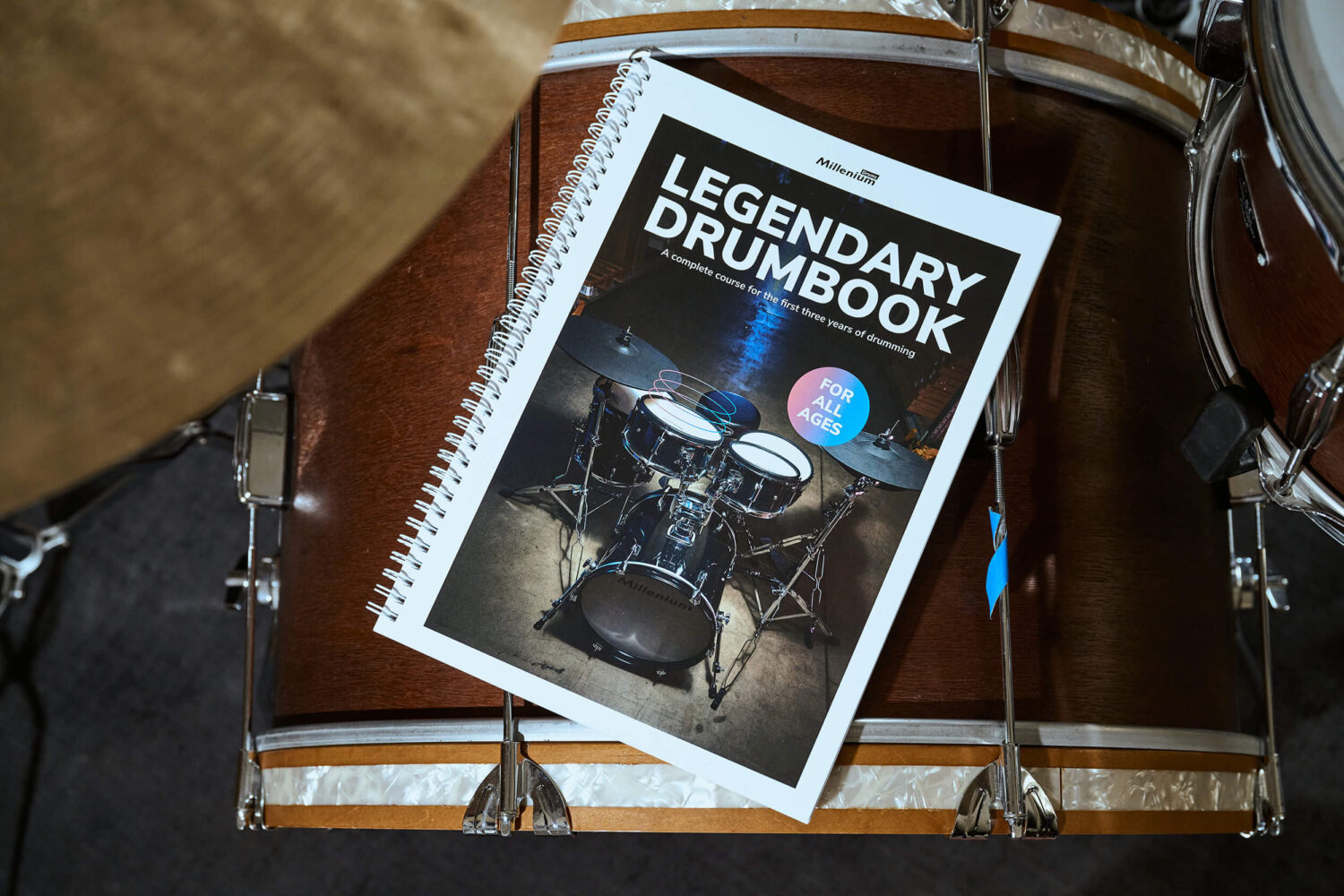 Bird's-eye view of the drumbook lying on a drum set component.